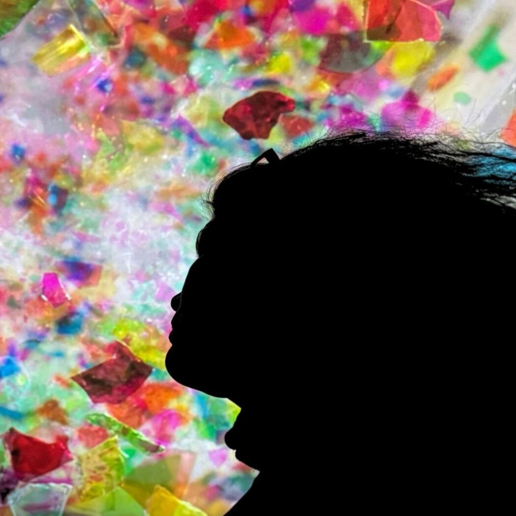 Close up of Meg's hand taking notes with a matcha latte nearby.